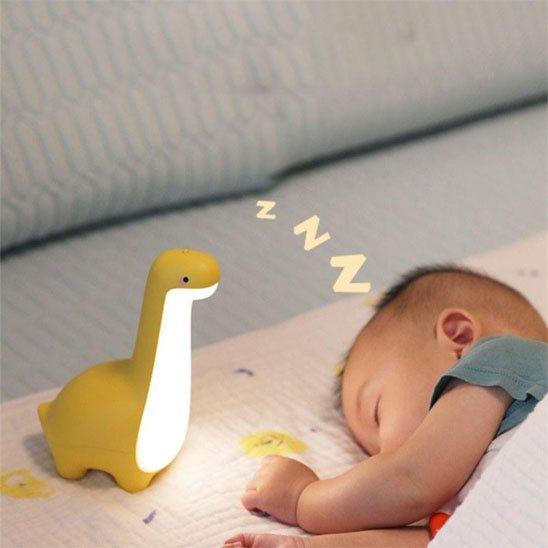 Veilleuse bébé dinosaure jaune accompagnant le sommeil